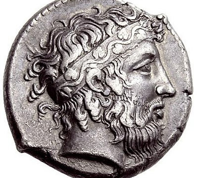 Ancient silver coin with a profile of Dionysus